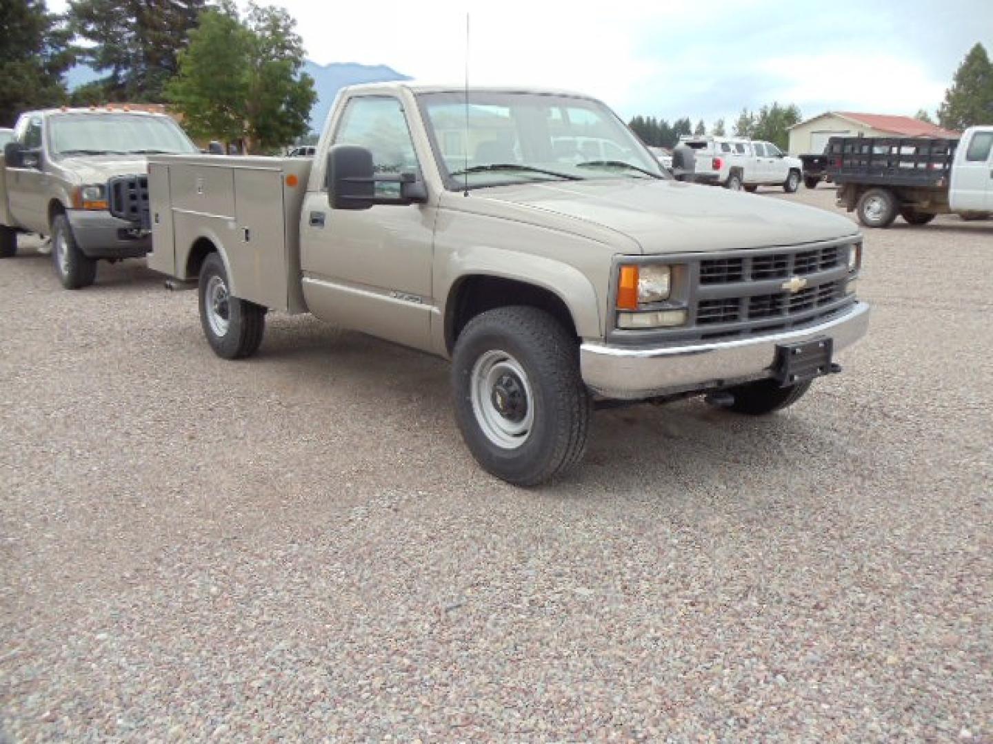 2000 Tan /Tan Chevrolet C/K 2500 Work Truck (1GBGK24R5YF) with an 5.7L V8 OHV 16V engine, Automatic transmission, located at 5465 Highway 2 W., Columbia Falls, MT, 59912, (406) 892-4407, 48.352188, -114.240929 - This truck is equipped with AC only 8 Foot Utility Box Good tires - Photo#0