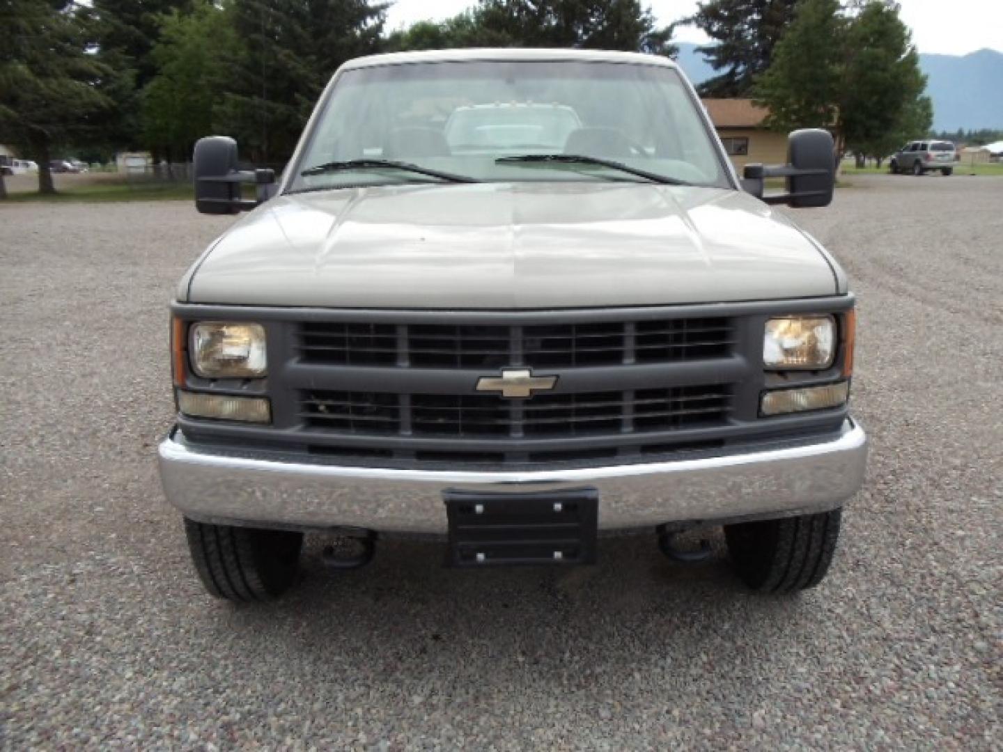 2000 Tan /Tan Chevrolet C/K 2500 Work Truck (1GBGK24R5YF) with an 5.7L V8 OHV 16V engine, Automatic transmission, located at 5465 Highway 2 W., Columbia Falls, MT, 59912, (406) 892-4407, 48.352188, -114.240929 - This truck is equipped with AC only 8 Foot Utility Box Good tires - Photo#1