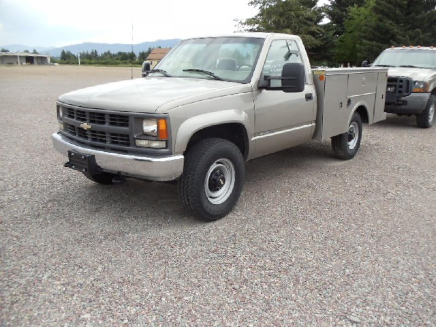 2000 Tan /Tan Chevrolet C/K 2500 Work Truck (1GBGK24R5YF) with an 5.7L V8 OHV 16V engine, Automatic transmission, located at 5465 Highway 2 W., Columbia Falls, MT, 59912, (406) 892-4407, 48.352188, -114.240929 - This truck is equipped with AC only 8 Foot Utility Box Good tires - Photo#2