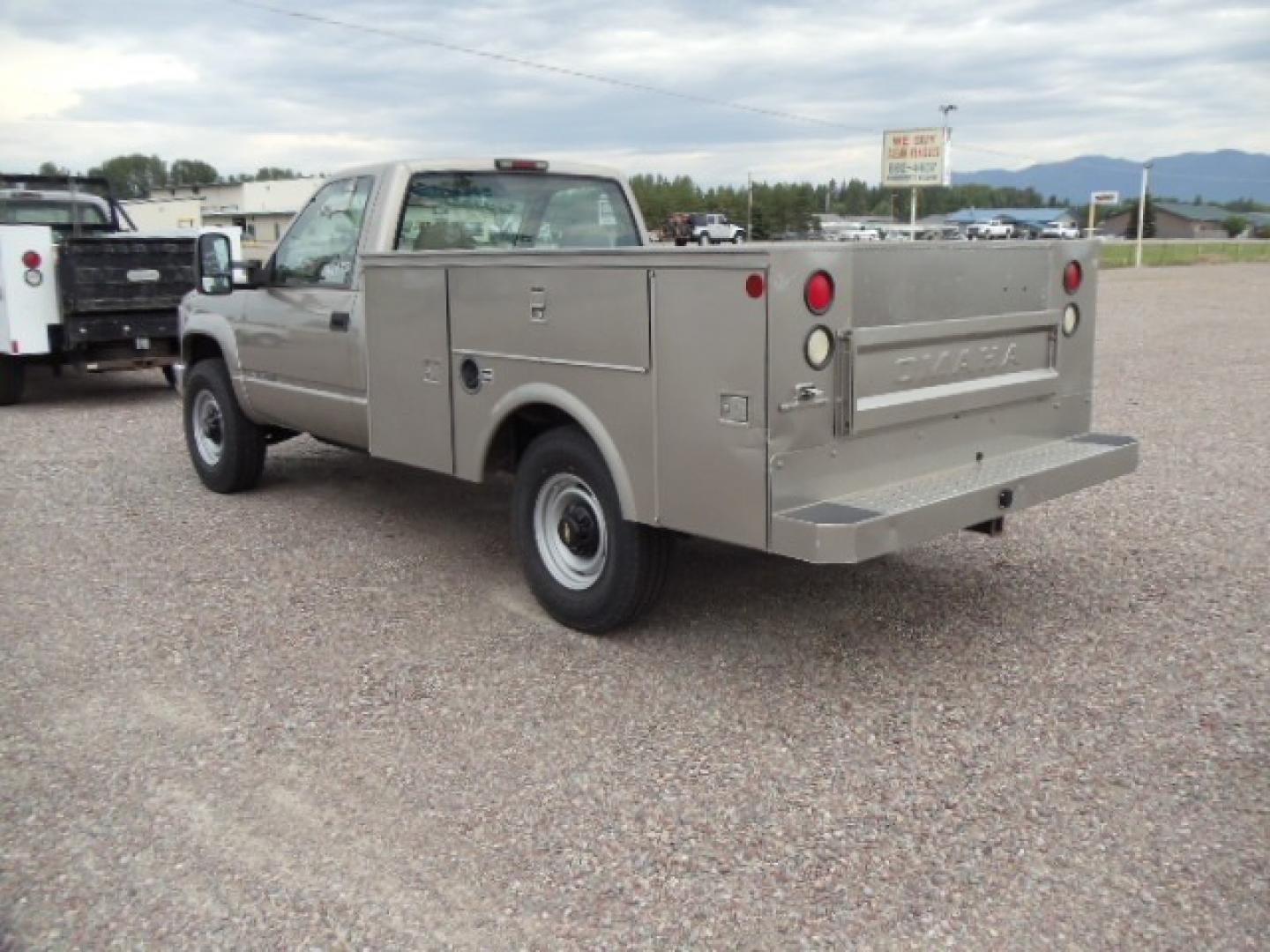 2000 Tan /Tan Chevrolet C/K 2500 Work Truck (1GBGK24R5YF) with an 5.7L V8 OHV 16V engine, Automatic transmission, located at 5465 Highway 2 W., Columbia Falls, MT, 59912, (406) 892-4407, 48.352188, -114.240929 - This truck is equipped with AC only 8 Foot Utility Box Good tires - Photo#4