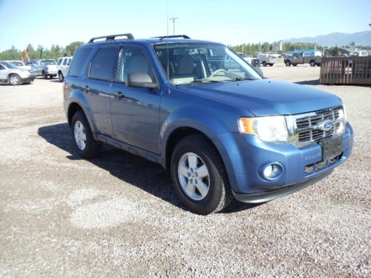 2010 Blue /Silver Ford Escape XLT 4WD (1FMCU9DGXAK) with an 3.0L V6 DOHC 24V engine, 6-Speed Automatic transmission, located at 5465 Highway 2 W., Columbia Falls, MT, 59912, (406) 892-4407, 48.352188, -114.240929 - Photo#0