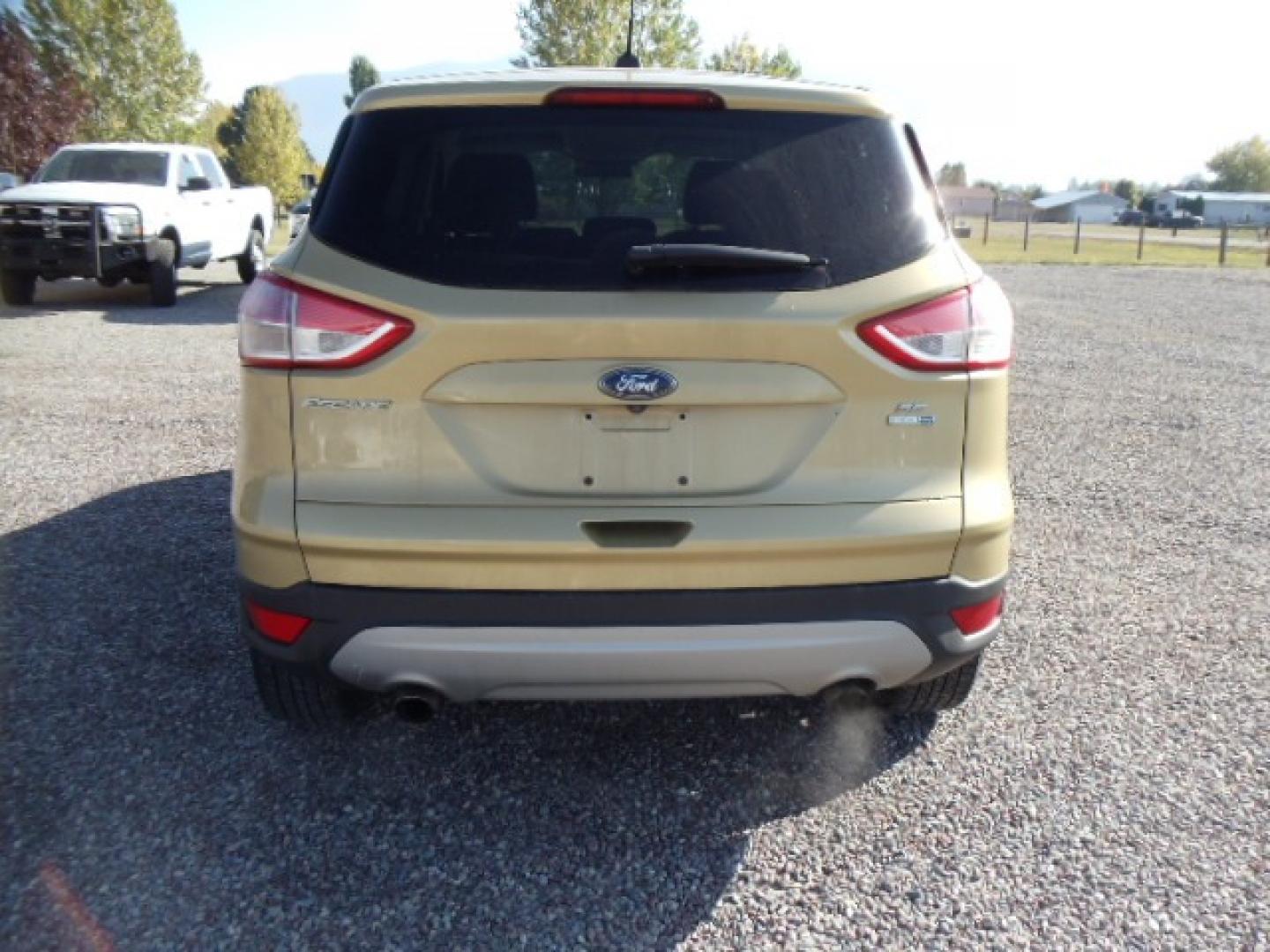 2015 Gold /Tan Ford Escape SE 4WD (1FMCU9G92FU) with an 2.0L L4 DOHC 16V engine, 6-Speed Automatic transmission, located at 5465 Highway 2 W., Columbia Falls, MT, 59912, (406) 892-4407, 48.352188, -114.240929 - Photo#5