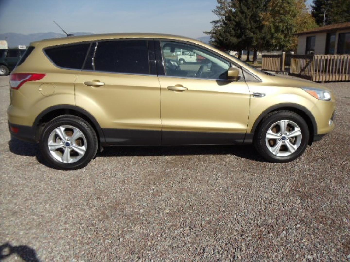 2015 Gold /Tan Ford Escape SE 4WD (1FMCU9G92FU) with an 2.0L L4 DOHC 16V engine, 6-Speed Automatic transmission, located at 5465 Highway 2 W., Columbia Falls, MT, 59912, (406) 892-4407, 48.352188, -114.240929 - Photo#7